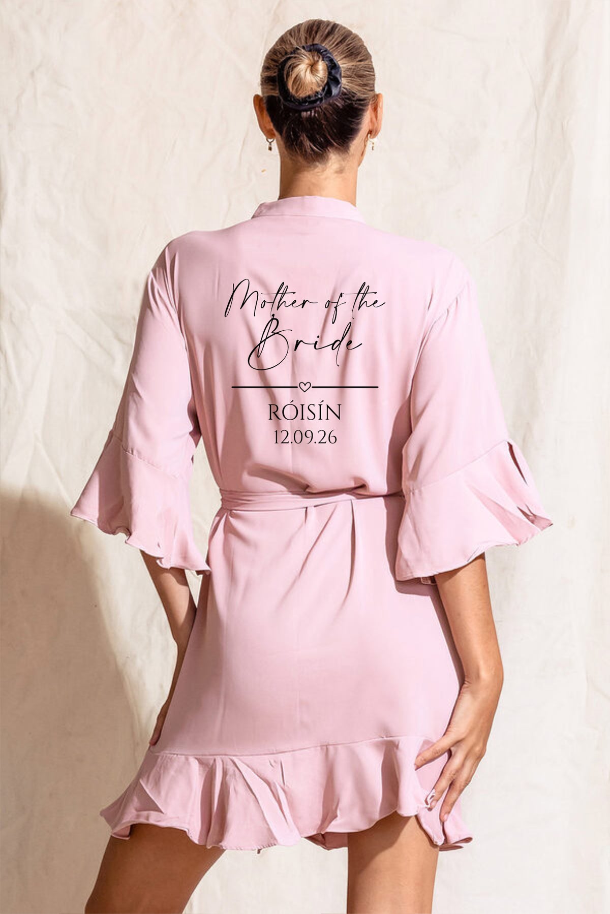Blush pink personalised crepe satin bridal party robe with ruffle hem and sleeves, back personalised with role, name and wedding date