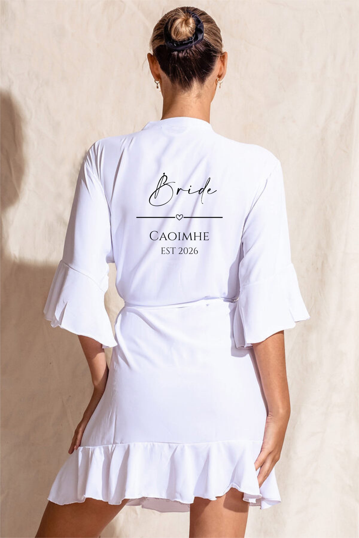 White crepe satin bride robe with ruffle hem and sleeves, back personalised with "Bride", name and Est. year